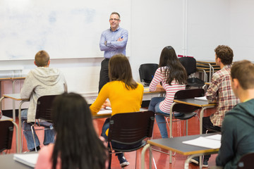 Attentive students with teacher in the classroom
