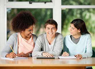 Student With Classmates Looking At Each Other In Classroom