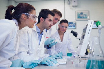 Serious researchers looking at computer screen in the lab