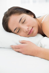 Fototapeta na wymiar Beautiful woman sleeping in bed with eyes closed