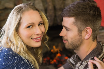 Fototapeta premium Close-up of a romantic couple in front of fireplace