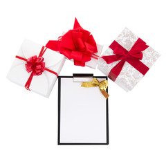gift boxes with red ribbon and gift list on white background