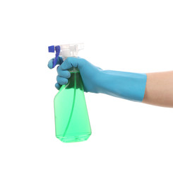 Hand in gloves holds spray bottle.