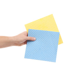 Hand holds two cleaning sponges.