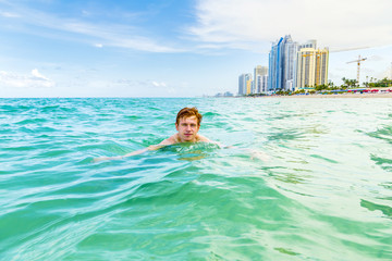 teenage boy enjoys swimming in the ocean