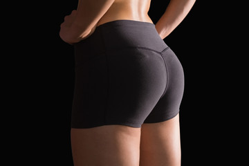 Fototapeta premium Mid section of sporty young woman wearing sportswear