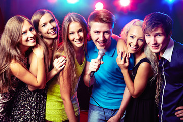 Young people singing at party