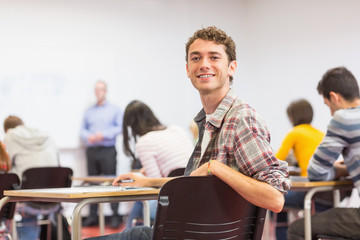 Male with blurred teachers students in classroom