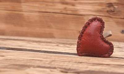 leather heart on wooden background