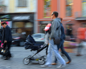 Parents walks with the child in the stroller
