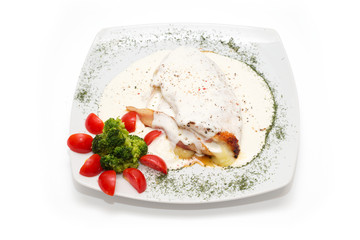 Chicken with gorgonzola, vegetables and bread on the plate
