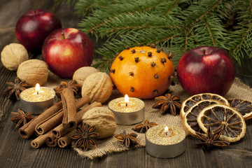 Christmas spices with decoration on wooden board
