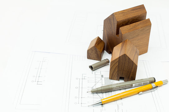 The wooden house model and blueprints