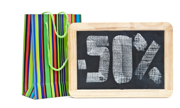 fifty percent written on blackboard with colorful shoping bag