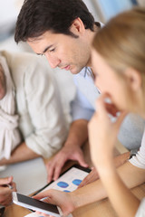 Fototapeta premium Business meeting around table with electronic devices