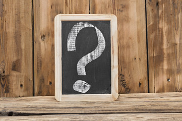 a chalkboard with a question marks written on it
