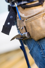 Hammer Hanging In Tool Belt Of Carpenter