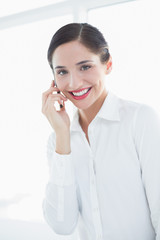 Smiling business woman using mobile phone