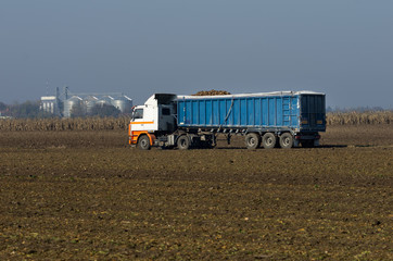 Loaded truck drives on field