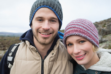 Fototapeta na wymiar Couple on a hike in the countryside against clear sky