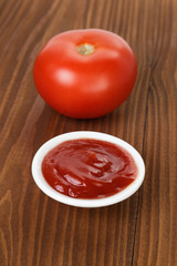 tomato sauce in bowl on wooden table