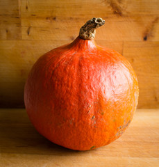 Fresh orange Hokkaido pumpkin on wooden background