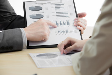 female and male hands pointing at business