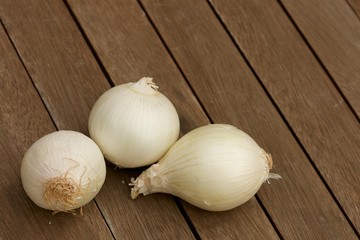 White onions on wooden table