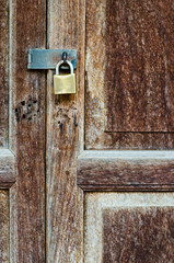 Rusty old key lock on old hardwood door