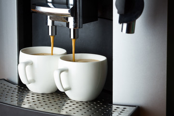 Two white cups of espresso