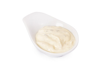 creamy sauce in a white bowl isolated