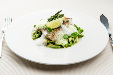 Sea bass fillet with asparagus infused with sauce foam