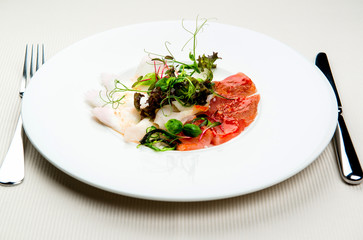 Cold appetizer, slices of trout and herring
