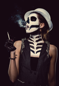 Woman with skeleton face art smoking, conceptual photo