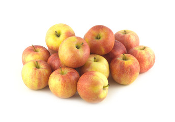 Heap of many ripe red and yellow apples isolated close up