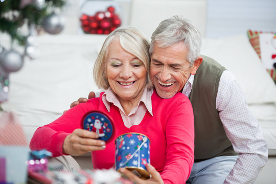 Happy Senior Couple Looking At Christmas Gift