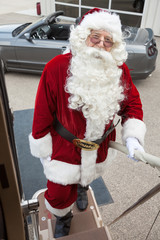 Santa Boarding Private Jet With Convertible In Background