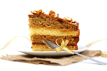 Piece of cake on saucer with spoon.
