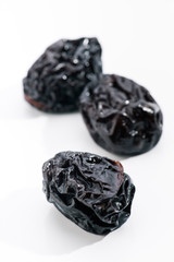 group of prunes on white base