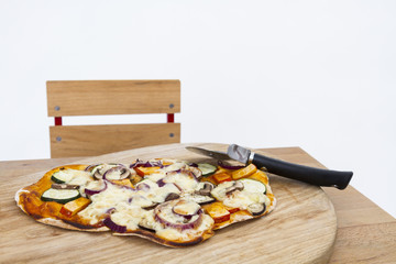 pizza with cutter on small desk