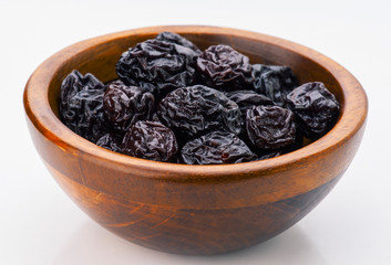prunes group in wooden bowl