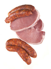pork chops and sausage isolated on a white background