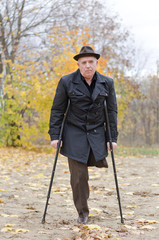 Disabled senior man on crutches
