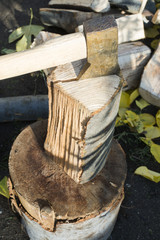 Ax chopping wood on chopping block