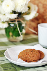 Still life of home-baked oatcakes, tea, and chrysanthemums