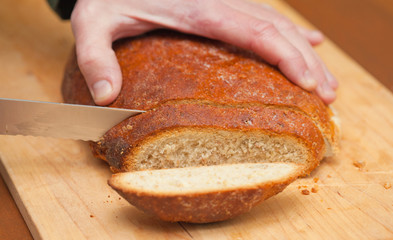 cutting freshly made bread