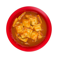 A large serving of ravioli in tomato sauce in a red bowl