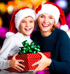 Happy mother with child hold box with gift on the christmas