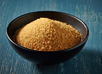 Cane sugar in a black bowl