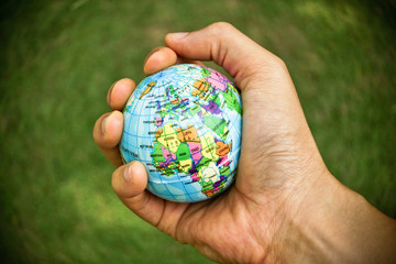 hand holding a globe